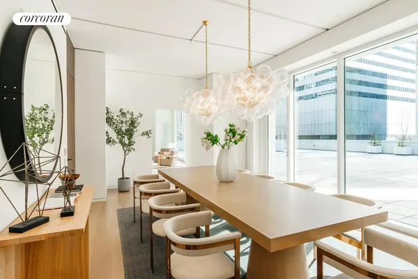 a dining room with furniture and a floor to ceiling window