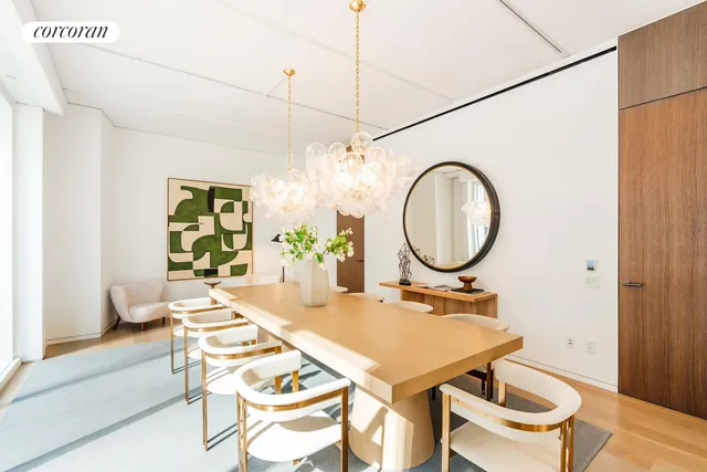 a dining room with furniture and a floor to ceiling window