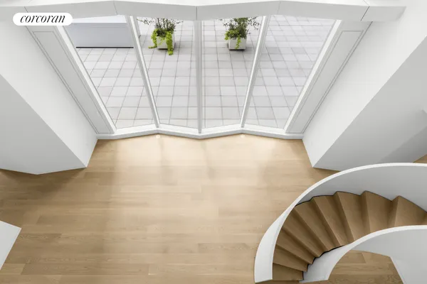 a spacious bedroom with a bed and glass window