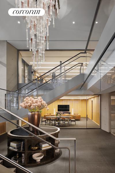 100 East 53rd Street, Unit 10A Manhattan, NY 10022 - Photo 32 of 35 a room with lots of wooden furniture and a chandelier