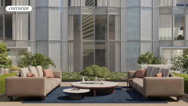 a view of a patio with couches table and chairs and potted plants
