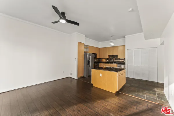 a kitchen with a refrigerator and a stove top oven