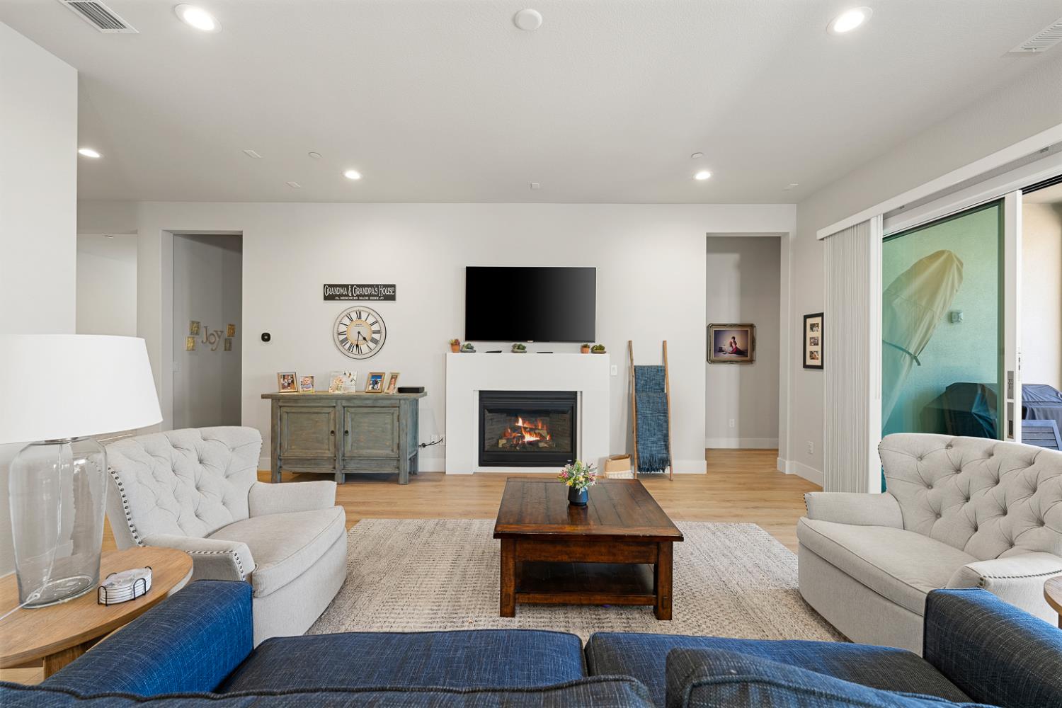 4228 Grey Hawk Street Folsom, CA 95630 - Photo 13 of 49 a living room with furniture a fireplace and a flat screen tv