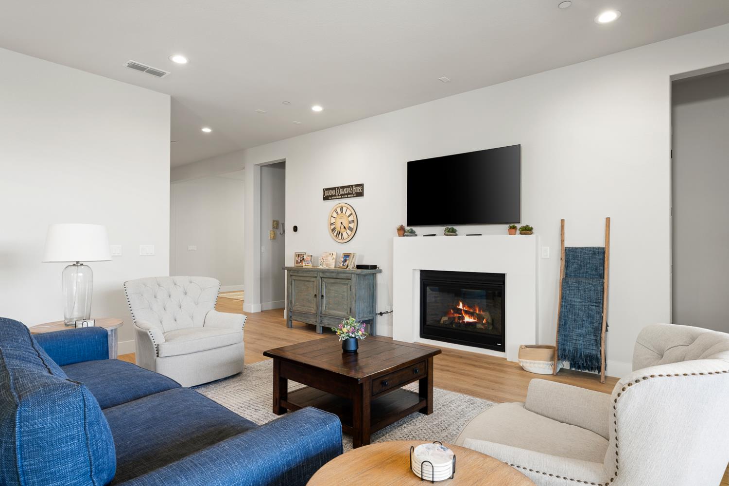 4228 Grey Hawk Street Folsom, CA 95630 - Photo 14 of 49 a living room with furniture a fireplace and a flat screen tv
