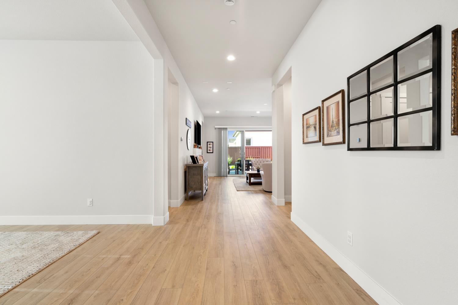 4228 Grey Hawk Street Folsom, CA 95630 - Photo 31 of 49 a view of a hallway with wooden floor and a living room