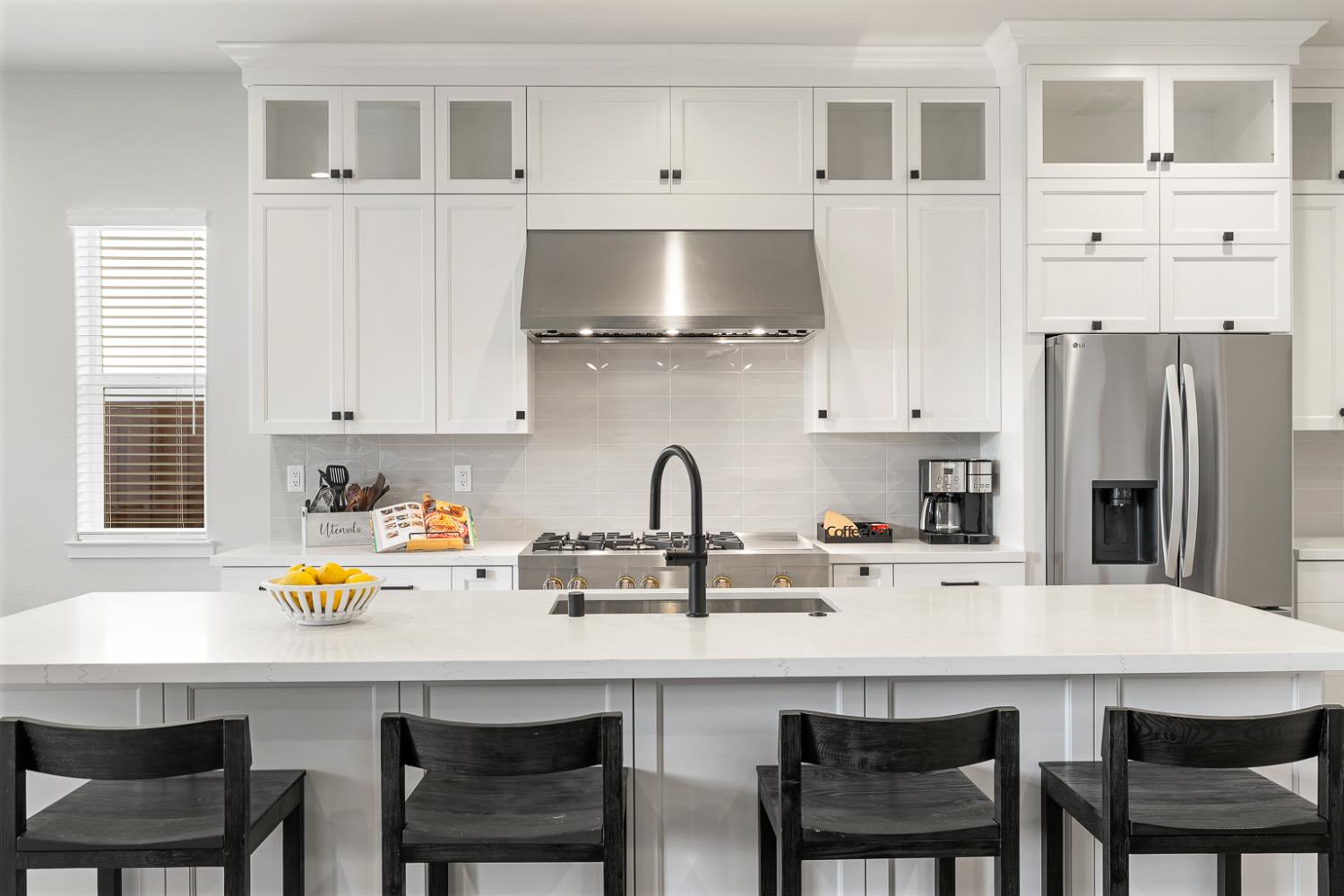 4228 Grey Hawk Street Folsom, CA 95630 - Photo 4 of 49 a kitchen with stainless steel appliances a white table chairs and a refrigerator