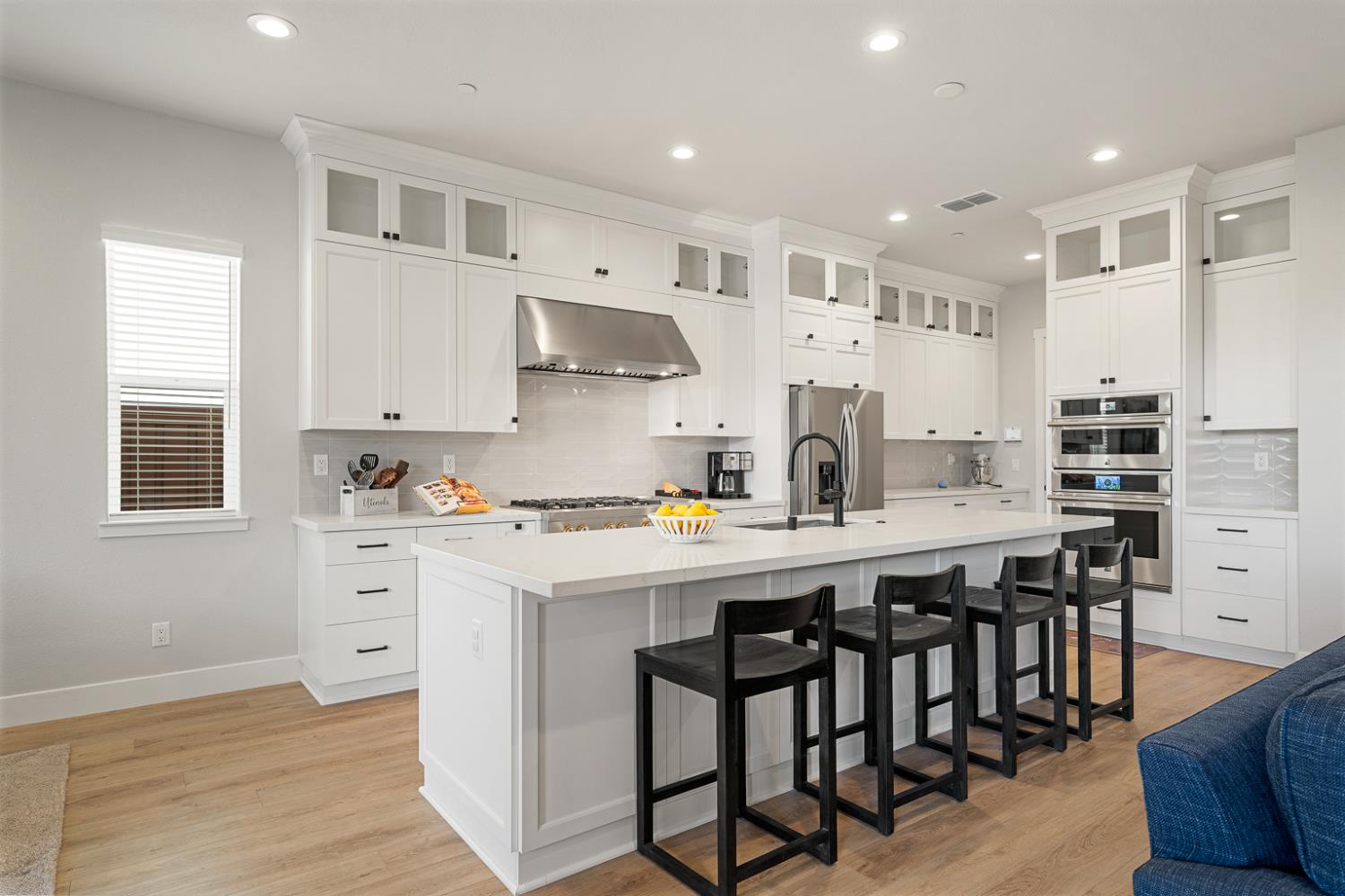 4228 Grey Hawk Street Folsom, CA 95630 - Photo 7 of 49 a kitchen with stainless steel appliances a white table chairs and a refrigerator