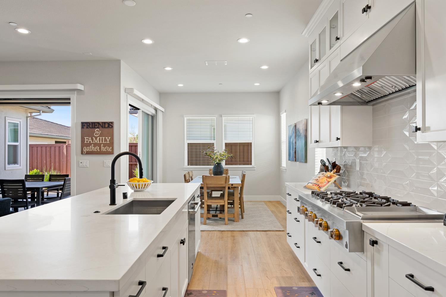 4228 Grey Hawk Street Folsom, CA 95630 - Photo 8 of 49 a kitchen with stainless steel appliances a stove a sink a refrigerator and chairs