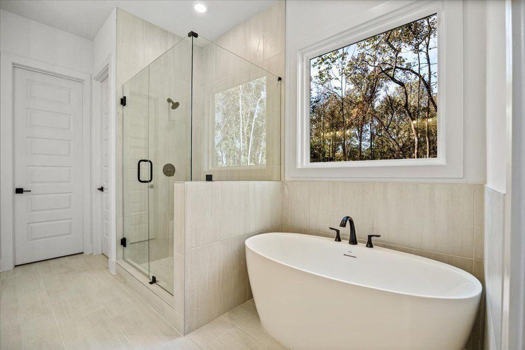 8280 Scarlett Grace Lane Gainesville, GA 30506 - Photo 17 of 48 a white bath tub sitting next to a shower