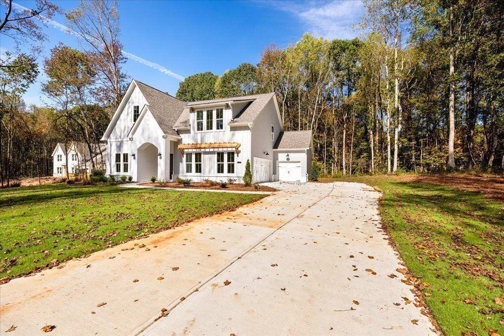 8280 Scarlett Grace Lane Gainesville, GA 30506 - Photo 2 of 48 a front view of a house with a yard