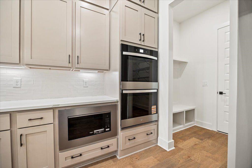 8280 Scarlett Grace Lane Gainesville, GA 30506 - Photo 26 of 48 a kitchen with granite countertop white cabinets and white appliances