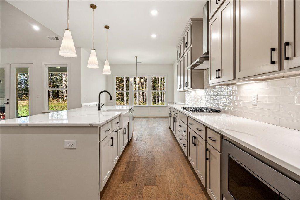 8280 Scarlett Grace Lane Gainesville, GA 30506 - Photo 28 of 48 a large kitchen with stainless steel appliances and a sink