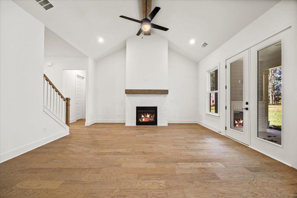 8280 Scarlett Grace Lane Gainesville, GA 30506 - Photo 31 of 48 a view of an empty room with a fireplace and a window