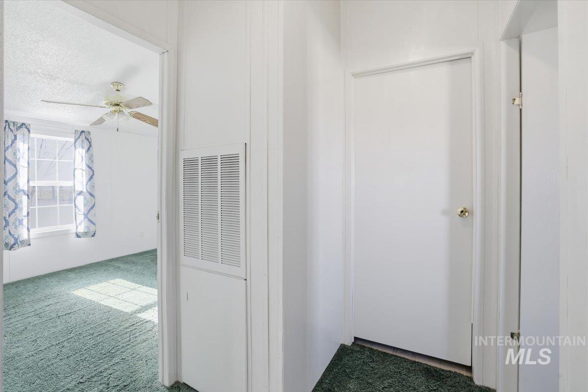 4320 West Pershall Road Marsing, ID 83639 - Photo 22 of 43 Hallway with dark carpet and a heating unit