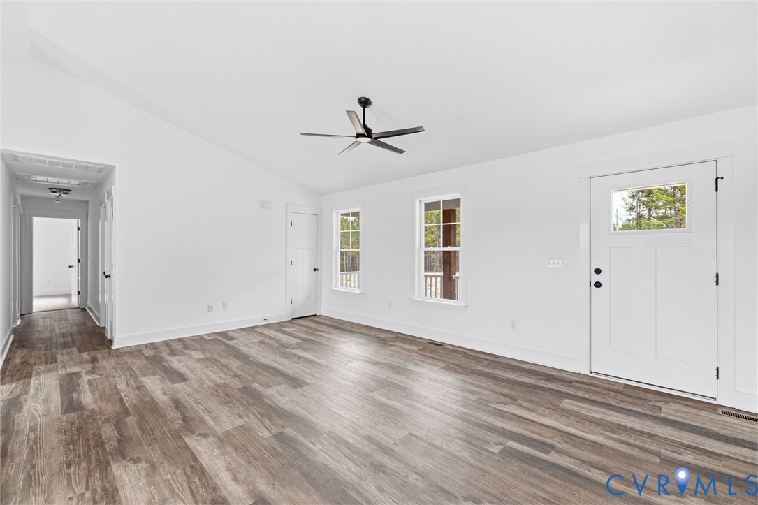 5245 Courtland Road Disputanta, VA 23842 - Photo 5 of 27 wooden floor in an empty room with a window