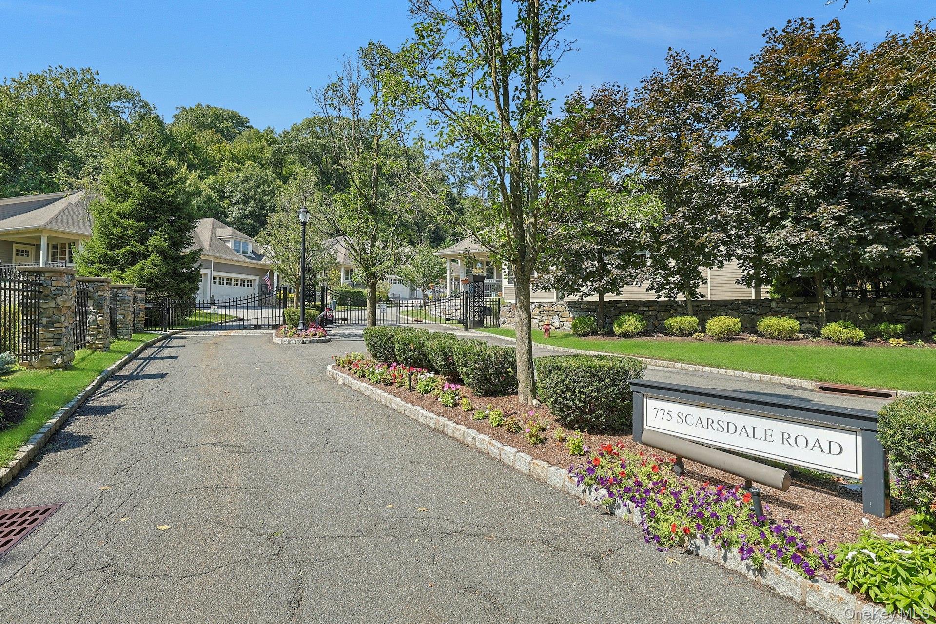 775 Scarsdale Road, Unit 7 Tuckahoe, NY 10707 - Photo 23 of 27 a view of a street with a bench and trees
