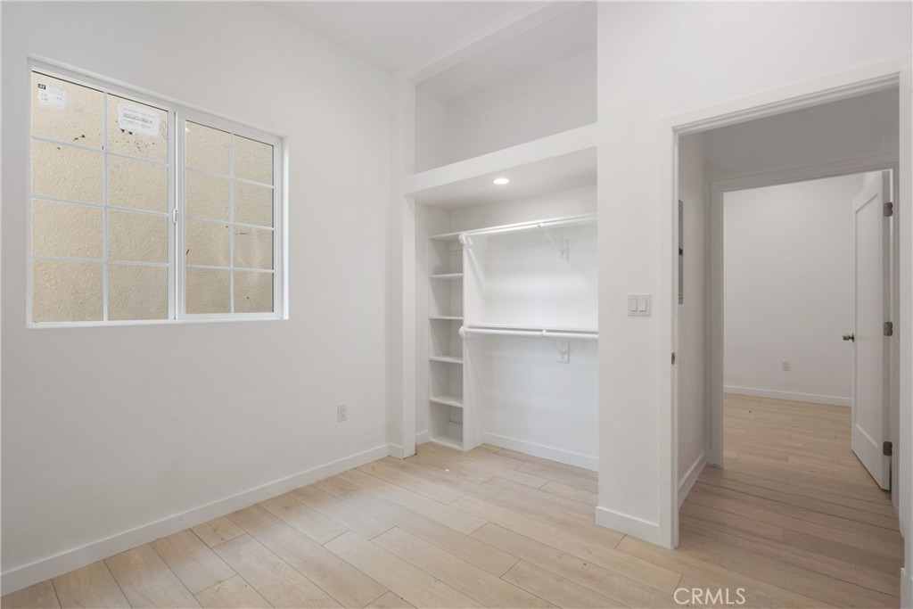 3929 Brighton Avenue, Unit 1/2 Los Angeles, CA 90062 - Photo 7 of 7 an empty room with windows and closet