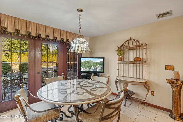 a bedroom with a bed a mirror and dresser