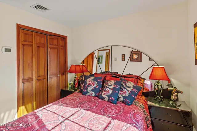 a bedroom with a large bed and a window