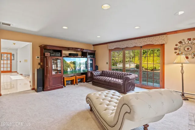 a bathroom with a sink a toilet and a large mirror