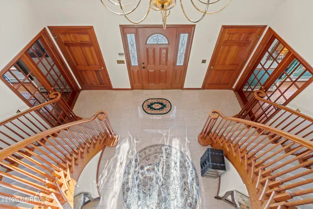 a view of a hallway with wooden floor and windows