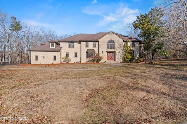 a view of an entryway with wooden floor and a rug