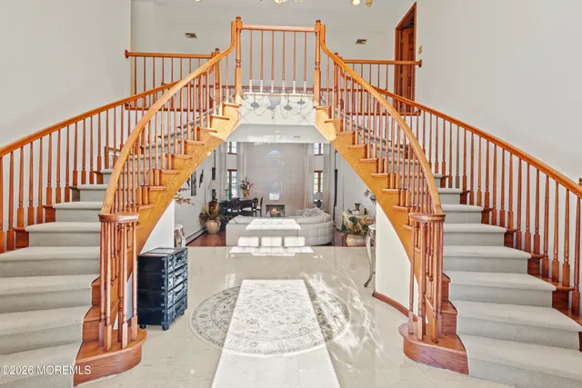 a living room with furniture and a large mirror