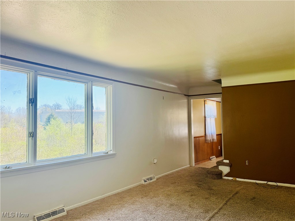 25911 Tryon Road Bedford, OH 44146 - Photo 18 of 49 Carpeted spare room with baseboards and visible vents