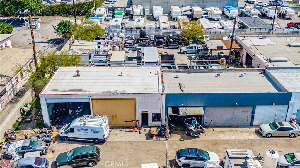 11669 Firestone Boulevard Norwalk, CA 90650 - Photo 13 of 23 a view of a patio with couches table and chairs under an umbrella