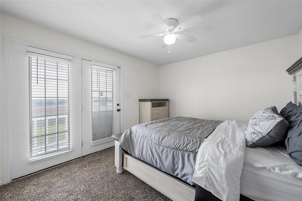 5112 Old Caufield Ranch Road McGregor, TX 76657 - Photo 27 of 38 Carpeted bedroom featuring access to outside and a ceiling fan