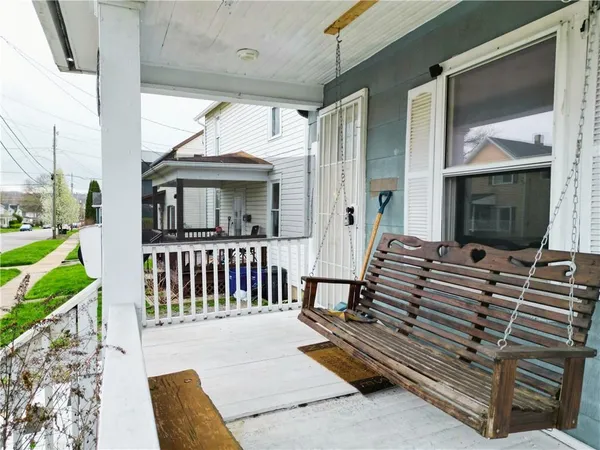 a view of a porch with wooden floor and furniture