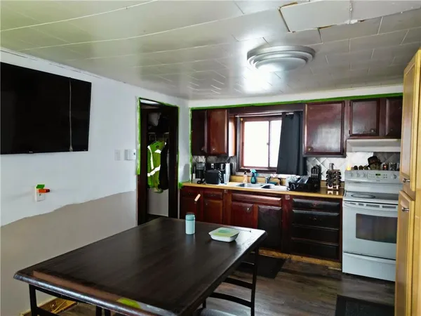 a kitchen with stainless steel appliances granite countertop a stove refrigerator and microwave