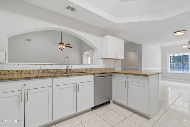 a view of a room with wooden floor and chandelier