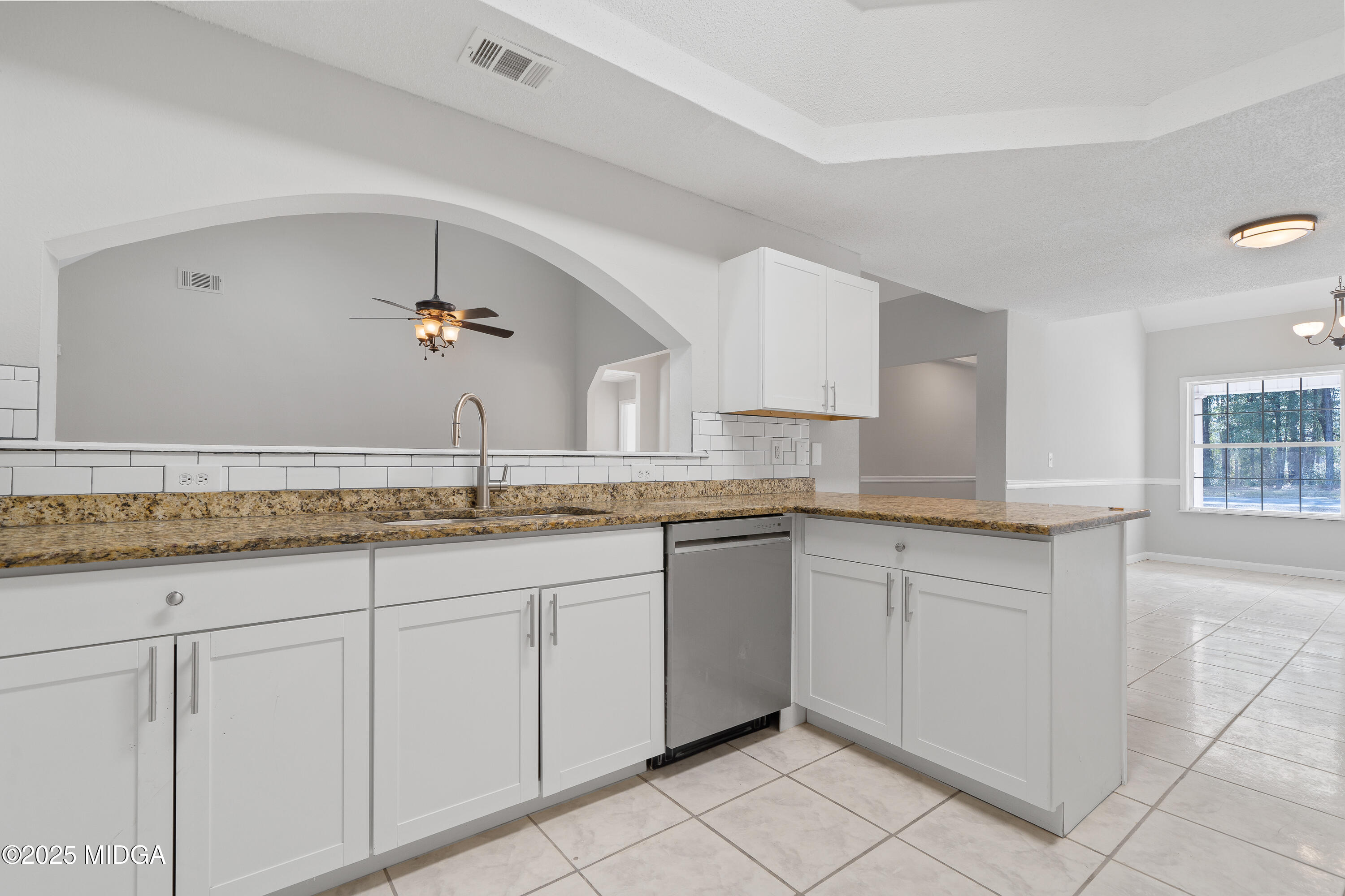 7513 Columbus Road Lizella, GA 31052 - Photo 12 of 56 a bathroom with a granite countertop sink and white cabinets
