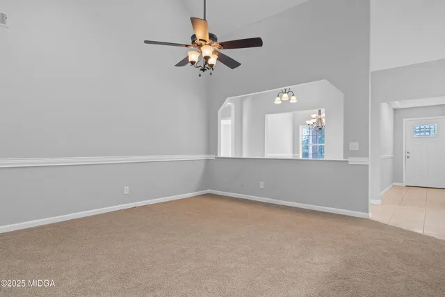 a view of room with a ceiling fan and window