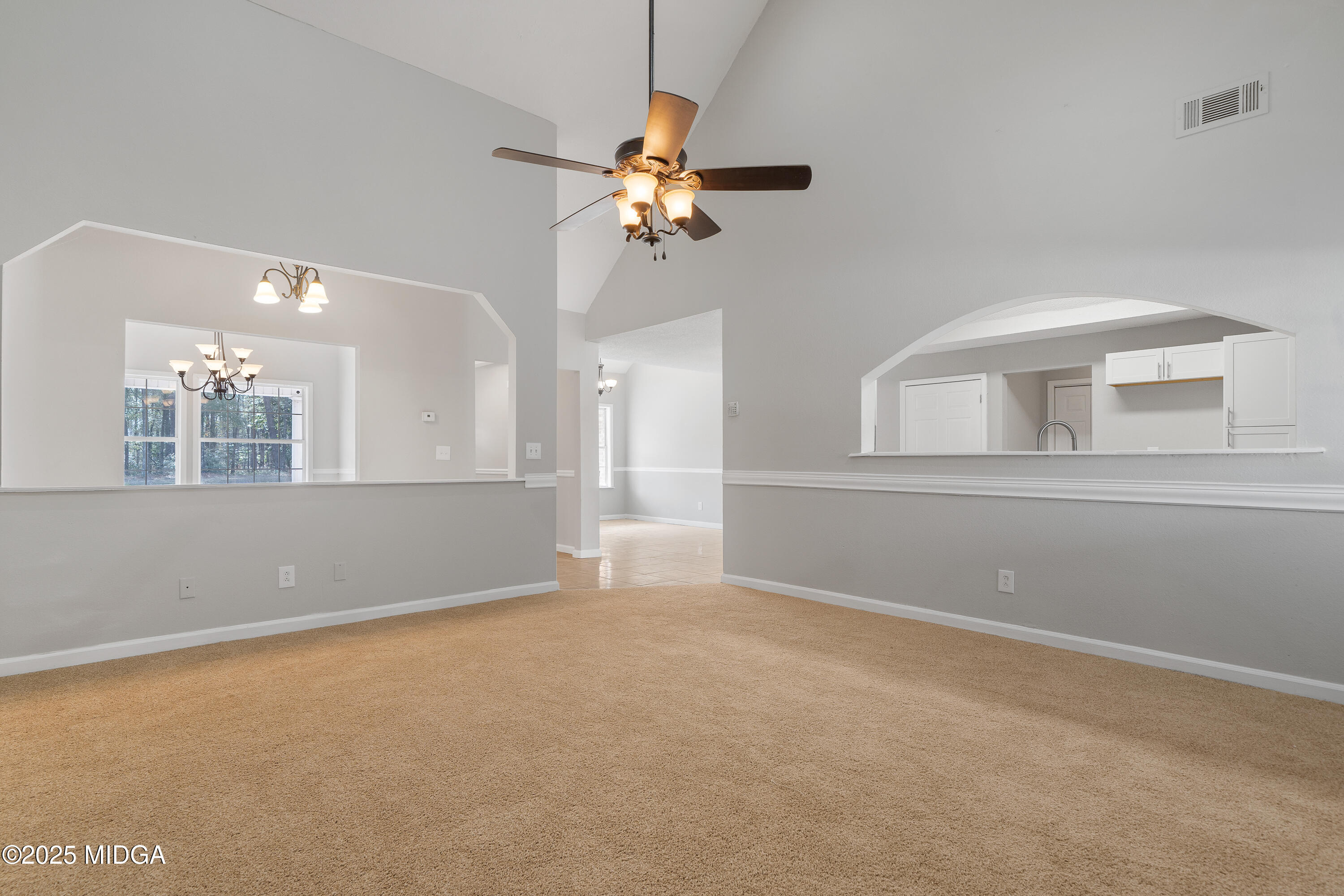 7513 Columbus Road Lizella, GA 31052 - Photo 16 of 56 a view of wooden floor and a chandelier fan in a room
