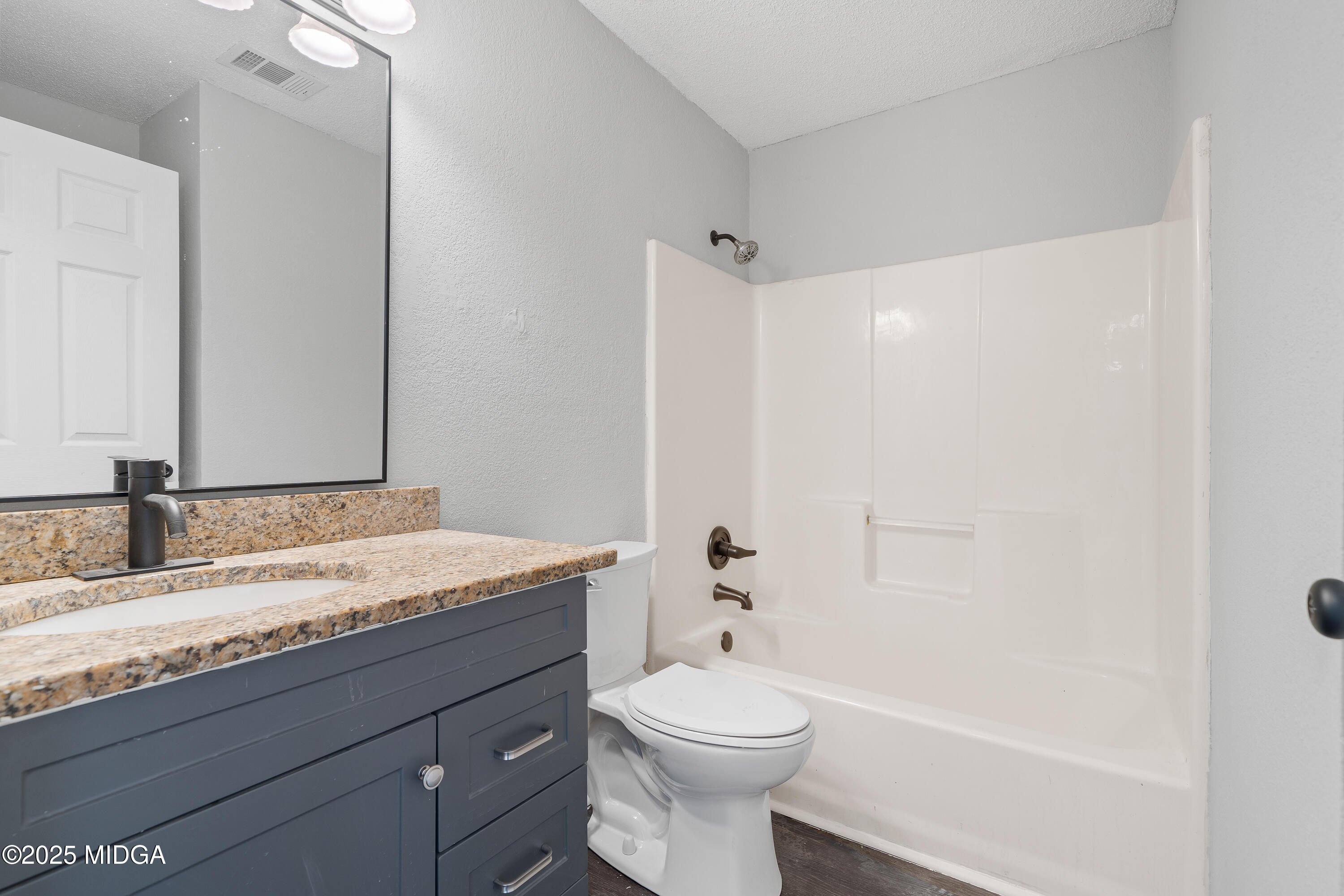 7513 Columbus Road Lizella, GA 31052 - Photo 21 of 56 a bathroom with a granite countertop sink toilet and shower
