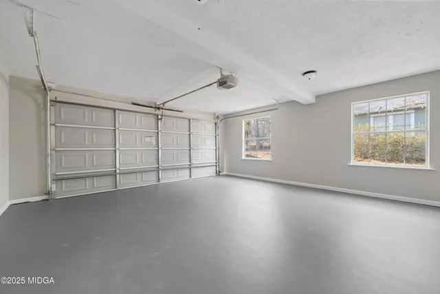 a view of an empty room with a ceiling fan