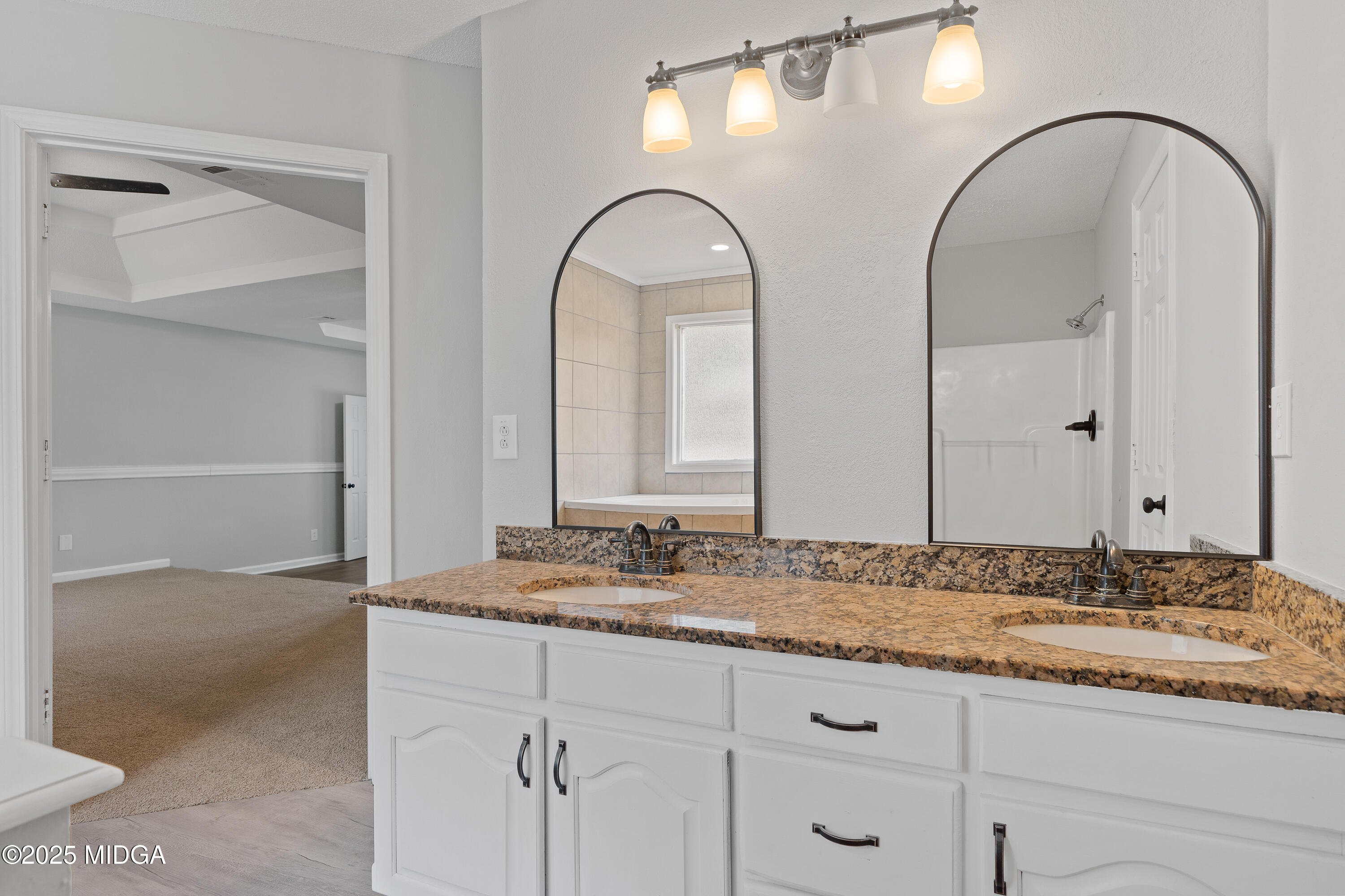 7513 Columbus Road Lizella, GA 31052 - Photo 34 of 56 a bathroom with a granite countertop sink a mirror and shower