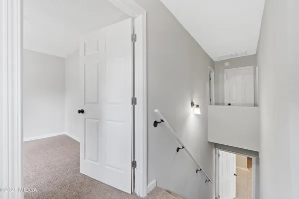 an empty room with wooden floor and white walls