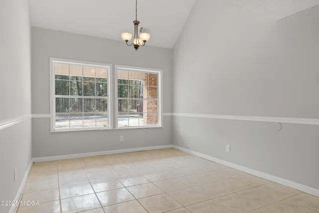a kitchen with granite countertop a stove sink and cabinets