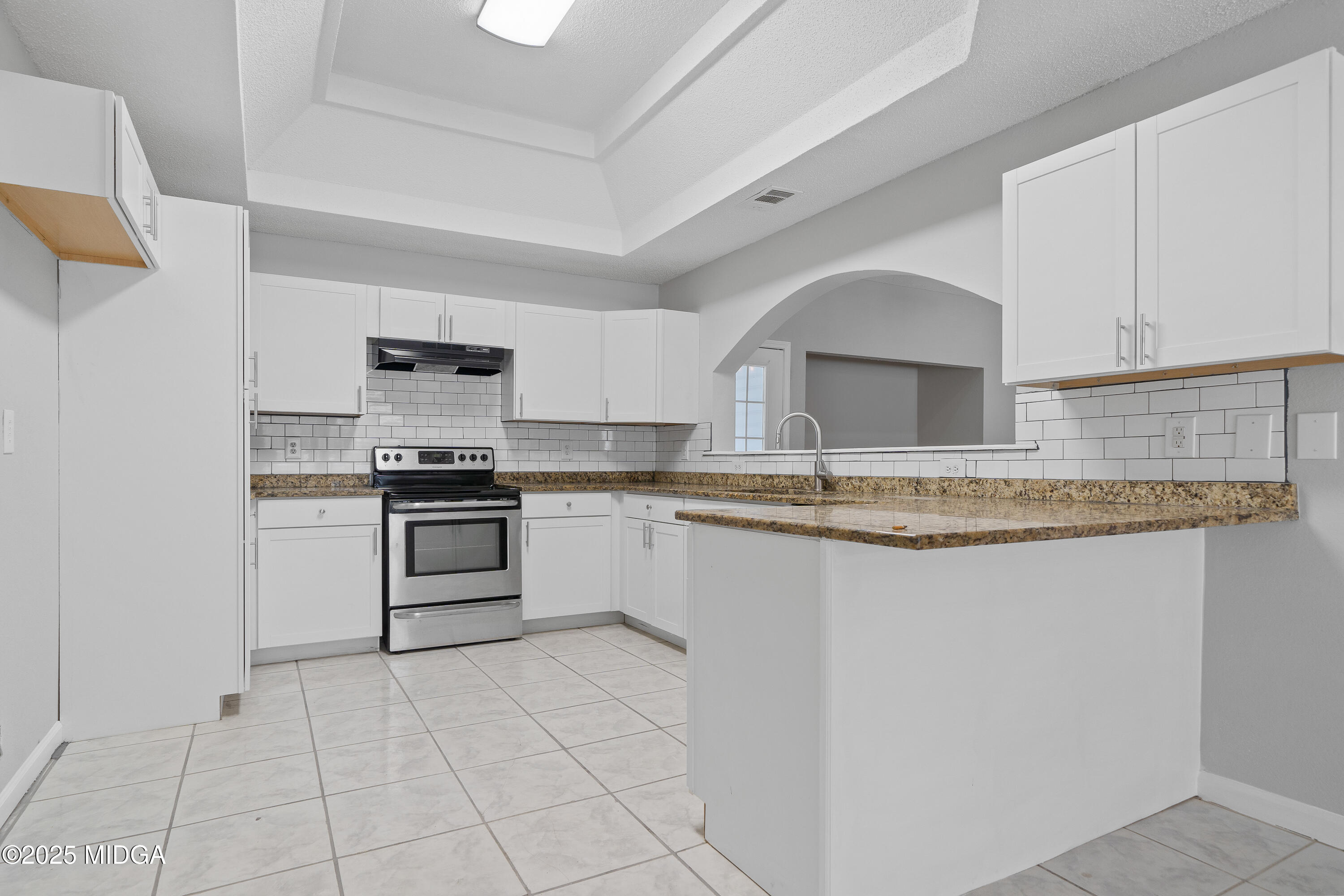 7513 Columbus Road Lizella, GA 31052 - Photo 7 of 56 a kitchen with granite countertop a stove sink and cabinets
