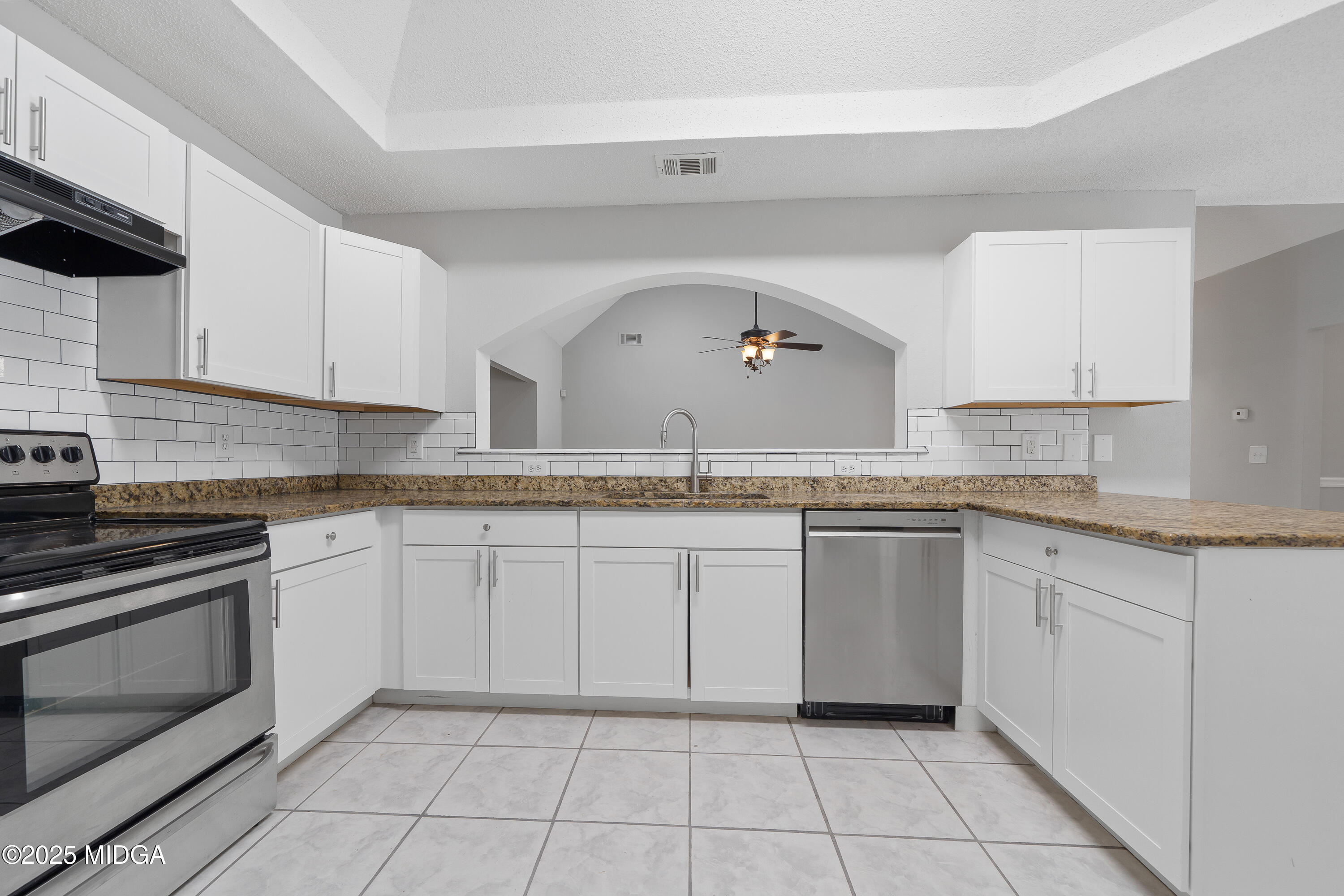 7513 Columbus Road Lizella, GA 31052 - Photo 9 of 56 a kitchen with granite countertop white cabinets and white appliances