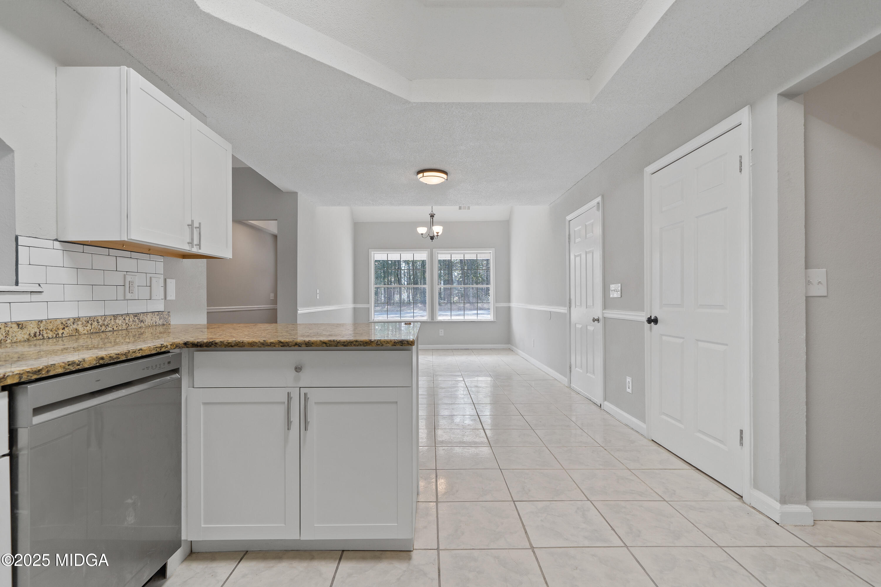 7513 Columbus Road Lizella, GA 31052 - Photo 10 of 56 a large white kitchen with granite countertop a sink