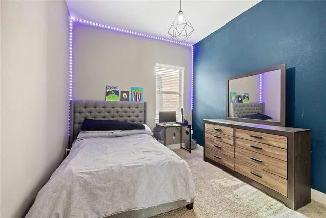 a bedroom with a bed and a dresser in it