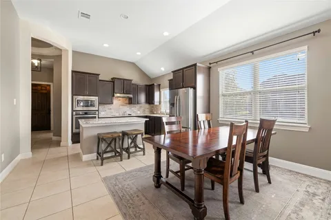 a view of a dining room with furniture and a kitchen