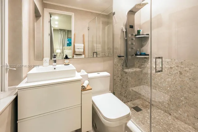 a bathroom with a toilet sink and shower