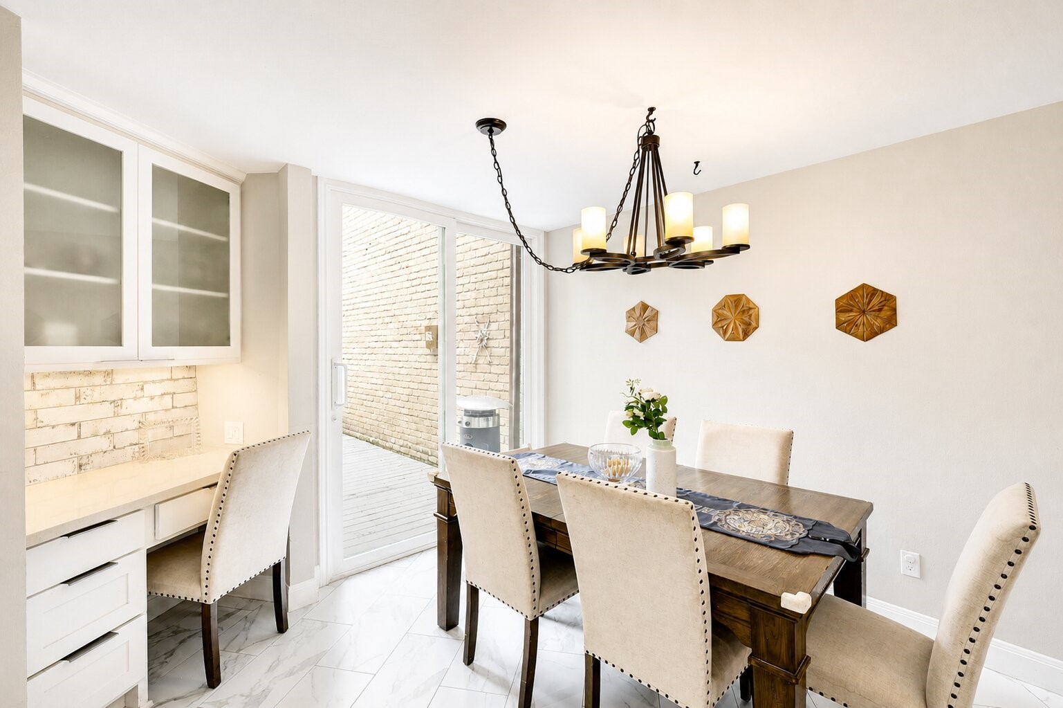 201 Vanderpool Lane, Unit 130 Houston, TX 77024 - Photo 11 of 41 This bright breakfast room features another floor-to-ceiling sliding glass door which leads to an expansive deck and comes with a dedicated built-in desk area that is perfect for a home office or kitchen command center.