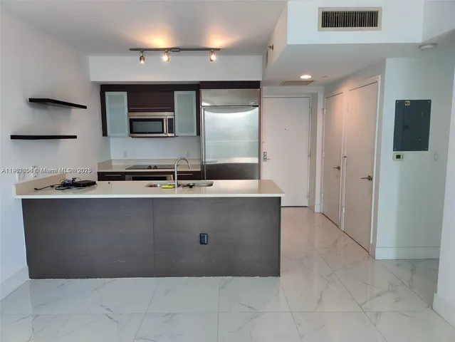a kitchen with a refrigerator and a sink