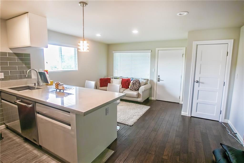 3110 Red River Street, Unit D315 Austin, TX 78705 - Photo 4 of 12 a kitchen with a sink and a refrigerator